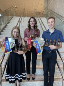 Three people with awards