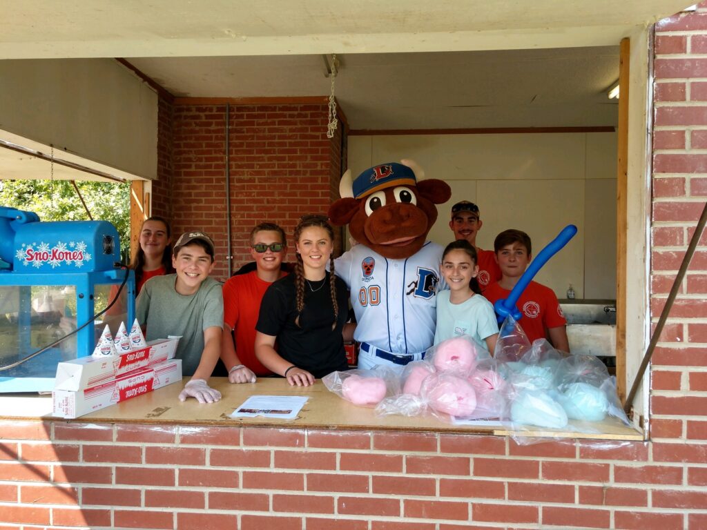 Sharpshooters teammates at concessions stand with sports mascot