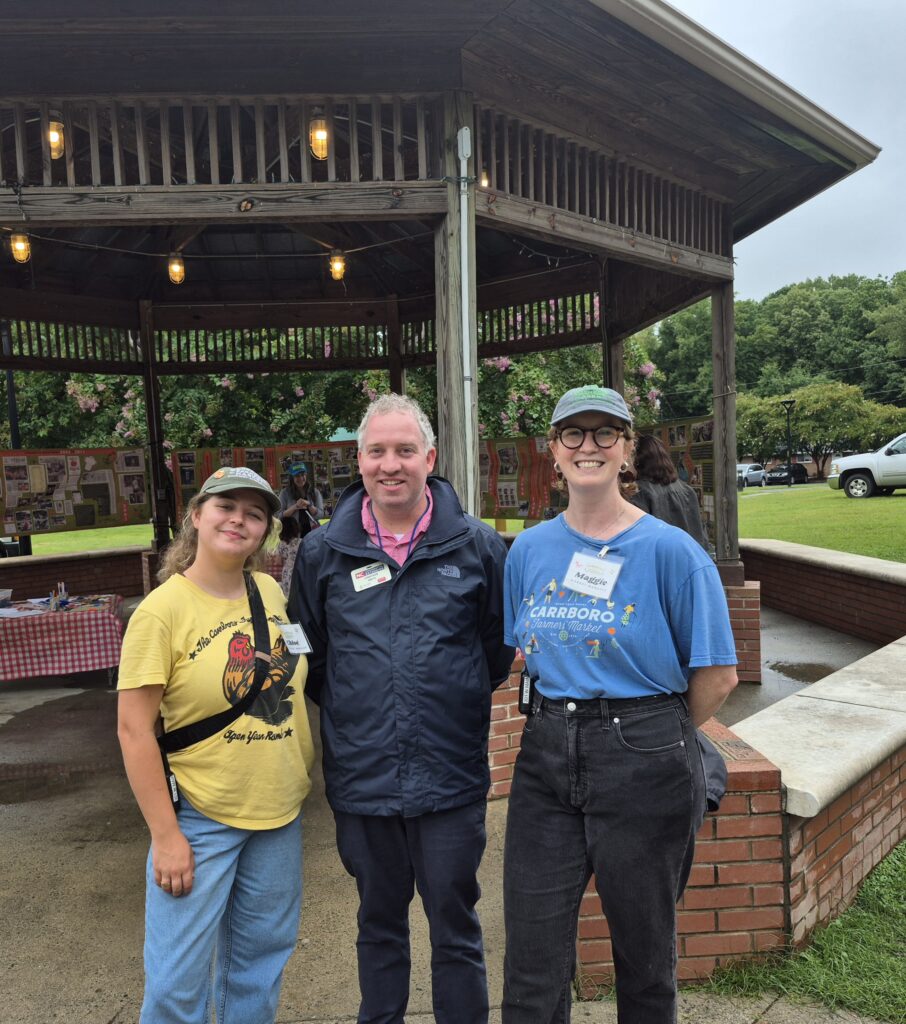 Extension Director posing with Carrboro Market Staff in Carrboro. 