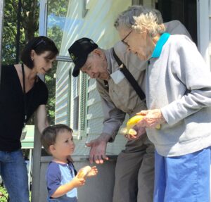 Volunteers delivering food to Meals on Wheels senior meals recipients at home.